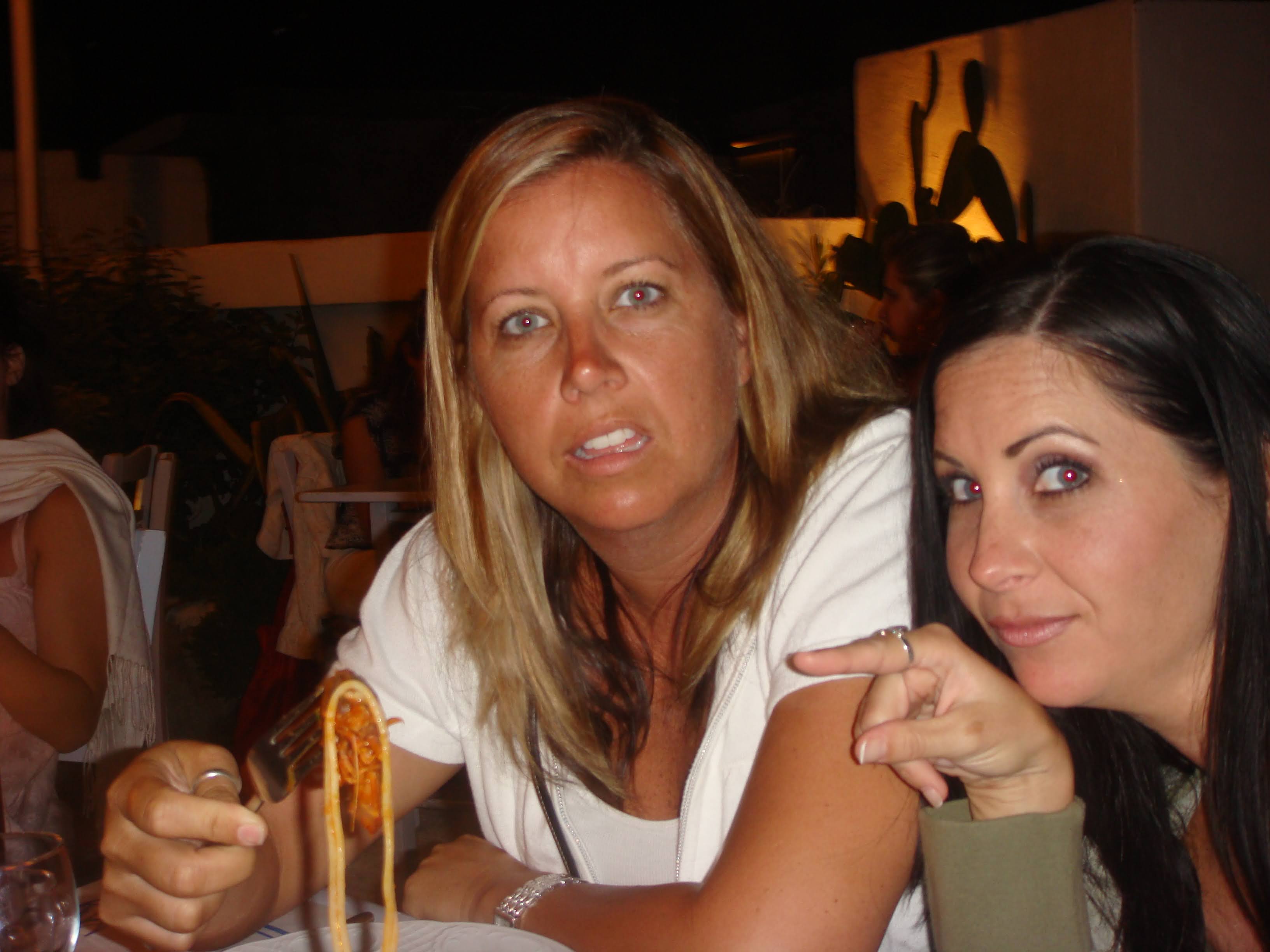 Mary wild-eyed at dinner in Greece